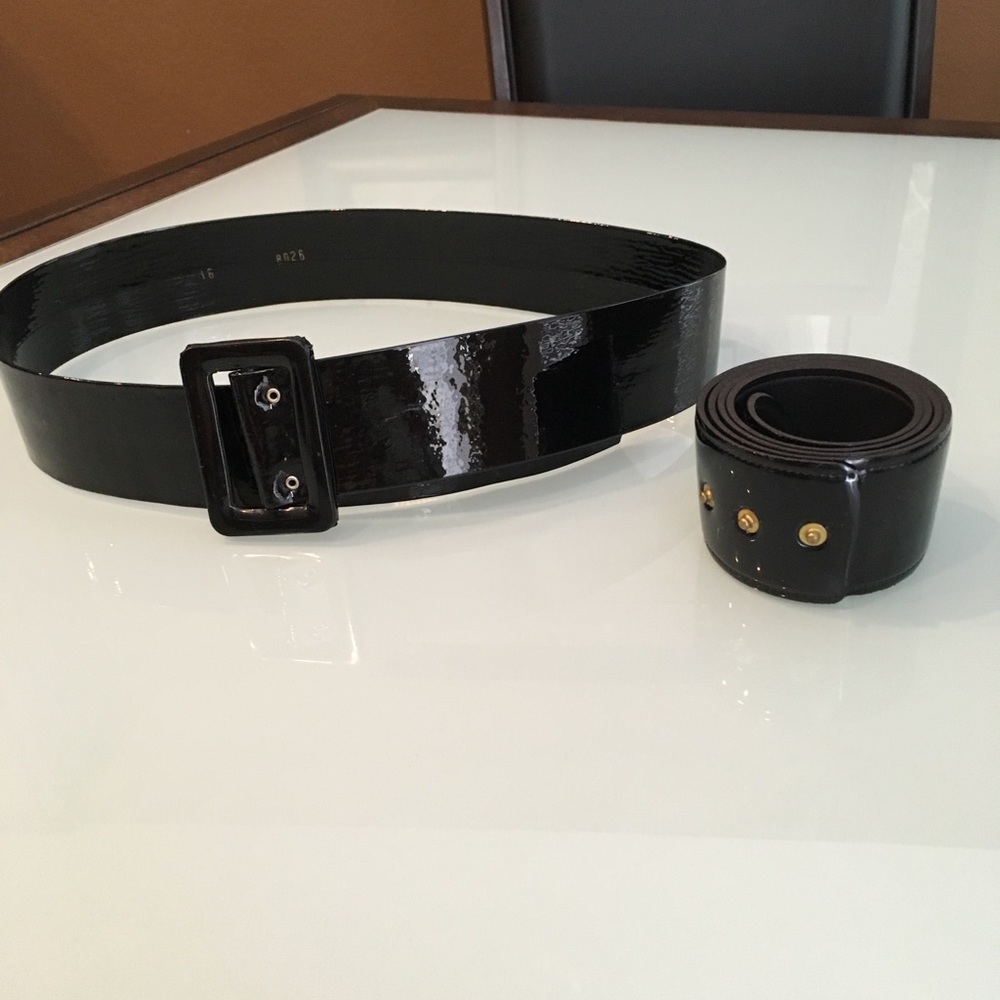 Two black shiny belts.
